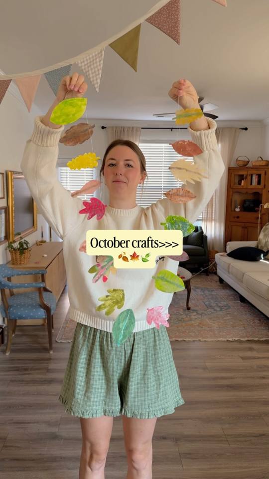 Nicole holding up a paper leaf garland